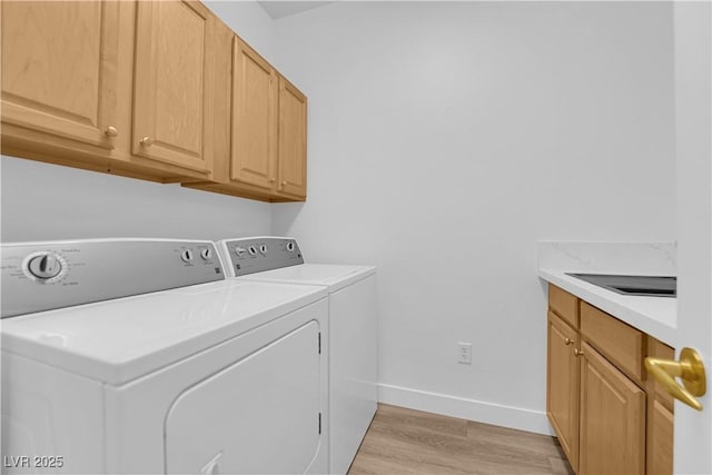 2167 Fairweather St, Henderson, NV 89052 - laundry room with washer and clothes dryer, light wood-style floors, and cabinet space