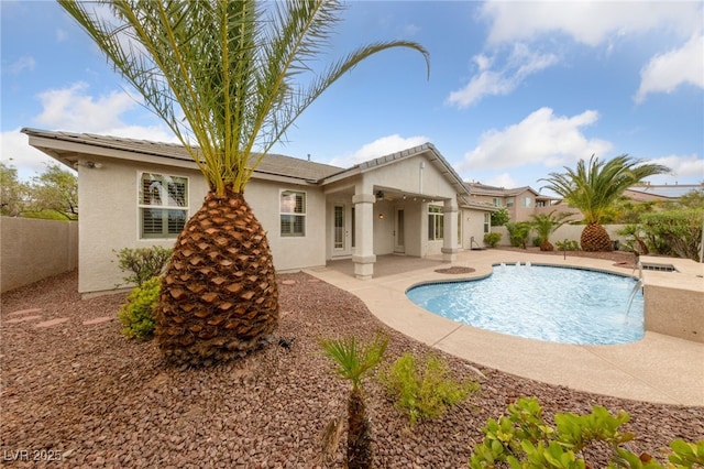 9208 Brilliant Ore Dr, Las Vegas, NV 89143 - back of property featuring stucco siding and a patio