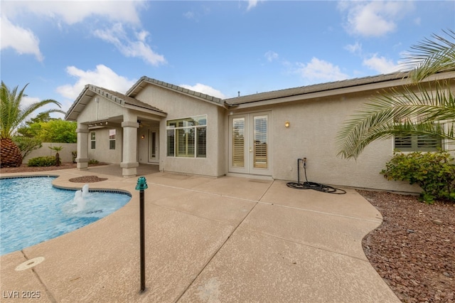 9208 Brilliant Ore Dr, Las Vegas, NV 89143 - back of property featuring french doors, stucco siding, and a patio