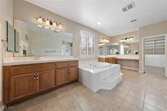 9208 Brilliant Ore Dr, Las Vegas, NV 89143 - full bathroom featuring a bath, a stall shower, tile patterned flooring, and two vanities