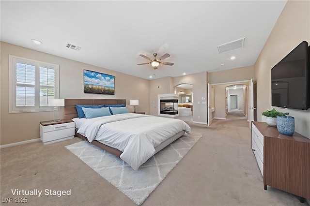 9208 Brilliant Ore Dr, Las Vegas, NV 89143 - bedroom featuring arched walkways, light colored carpet, ensuite bathroom, and recessed lighting