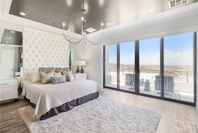 426 Tranquil Peak Ct, Henderson, NV 89012 - bedroom with access to outside, wood finished floors, a chandelier, and recessed lighting
