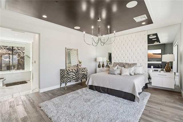 426 Tranquil Peak Ct, Henderson, NV 89012 - bedroom featuring a chandelier, wood finished floors, recessed lighting, and ensuite bath