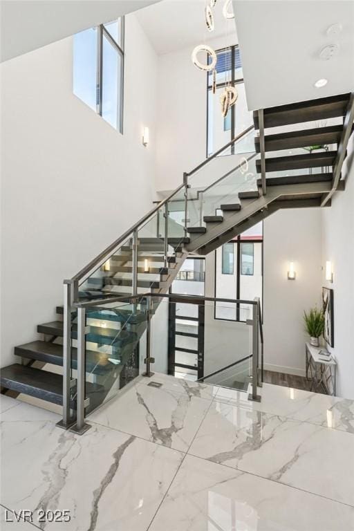 426 Tranquil Peak Ct, Henderson, NV 89012 - stairs with marble tiled floors and a towering ceiling