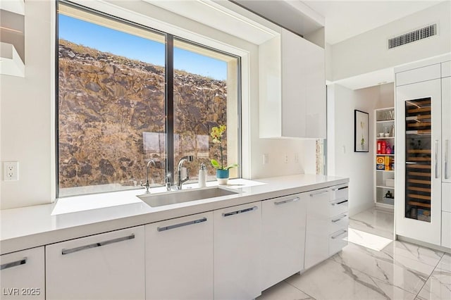 426 Tranquil Peak Ct, Henderson, NV 89012 - kitchen featuring modern cabinets, white cabinetry, and light countertops