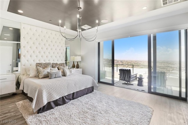 426 Tranquil Peak Ct, Henderson, NV 89012 - bedroom featuring access to outside, wood finished floors, and a chandelier