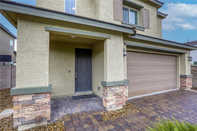 2807 Lindsey Springs St, Las Vegas, NV 89142 - property entrance with stucco siding, an attached garage, and stone siding