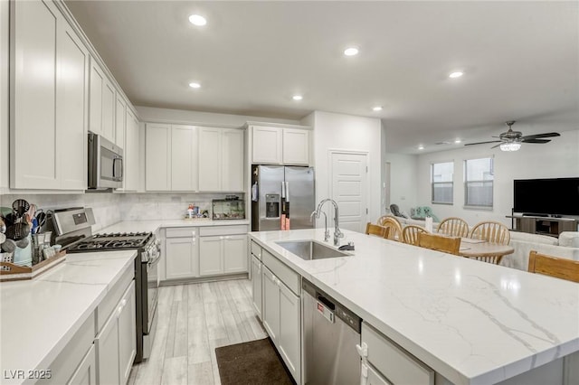 2807 Lindsey Springs St, Las Vegas, NV 89142 - kitchen with stainless steel appliances, ceiling fan, a center island with sink, open floor plan, and recessed lighting