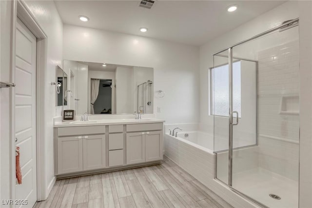 2807 Lindsey Springs St, Las Vegas, NV 89142 - full bathroom with a bath, a shower stall, double vanity, and recessed lighting