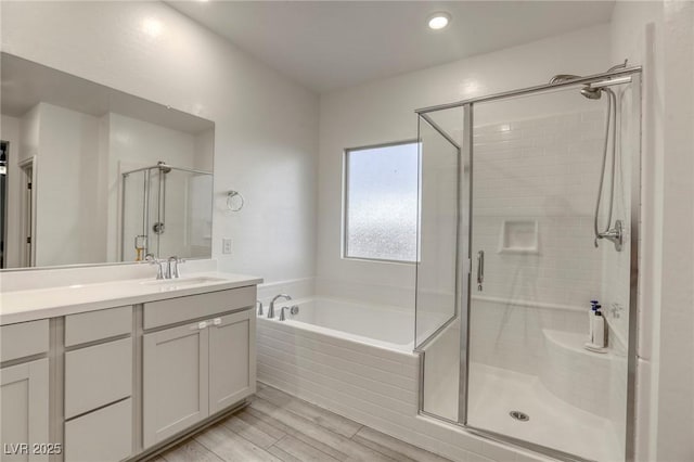 2807 Lindsey Springs St, Las Vegas, NV 89142 - bathroom with a stall shower, a bath, vanity, and wood finished floors