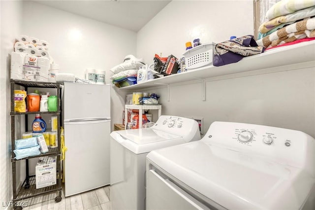 2807 Lindsey Springs St, Las Vegas, NV 89142 - laundry area featuring washer and dryer and light wood-style floors