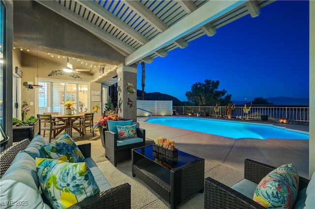 10800 Albright Pl, Las Vegas, NV 89134 - pool at twilight with an outdoor hangout area, a patio area, a fenced backyard, a ceiling fan, and outdoor dining space