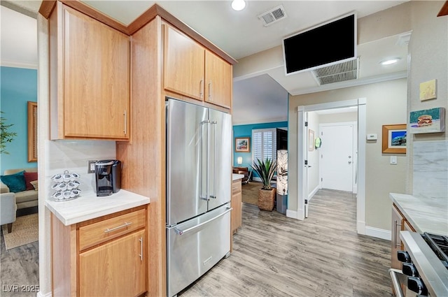 10800 Albright Pl, Las Vegas, NV 89134 - kitchen featuring high quality fridge, stove, light countertops, light wood finished floors, and light brown cabinets
