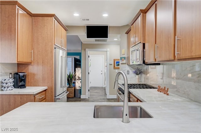 10800 Albright Pl, Las Vegas, NV 89134 - kitchen featuring stainless steel appliances, light countertops, tasteful backsplash, wood finished floors, and recessed lighting