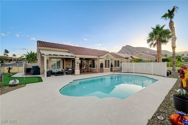 10800 Albright Pl, Las Vegas, NV 89134 - pool at dusk featuring an area to practice putting, outdoor lounge area, a patio, and a fenced backyard