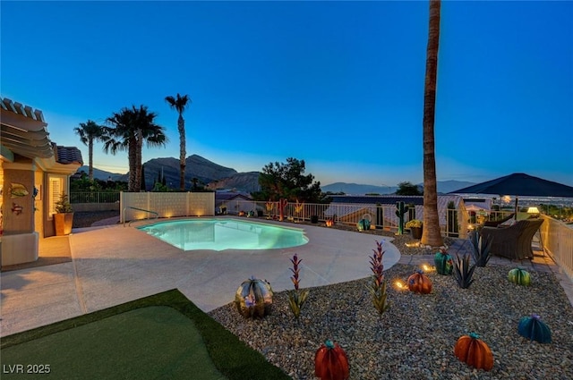 10800 Albright Pl, Las Vegas, NV 89134 - pool at dusk featuring a patio, a fenced backyard, and a mountain view