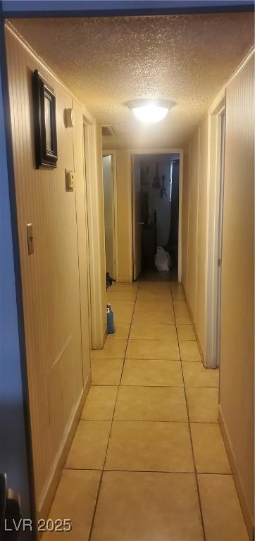 3315 Tabor Ave, North Las Vegas, NV 89030 - corridor with light tile patterned flooring and a textured ceiling