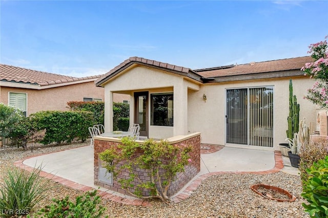4508 Regalo Bello St, Las Vegas, NV 89135 - view of exterior entry with stucco siding, a patio area, and solar panels