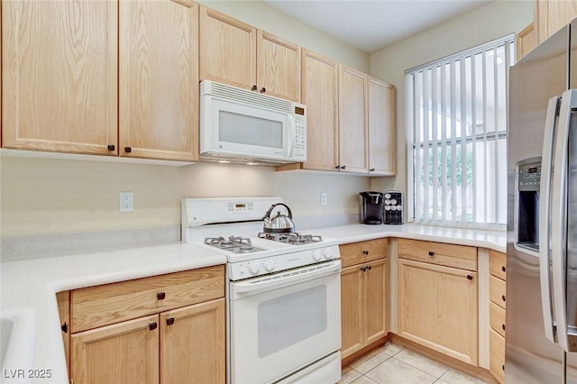 4508 Regalo Bello St, Las Vegas, NV 89135 - kitchen with white appliances, light brown cabinets, light tile patterned flooring, and light countertops