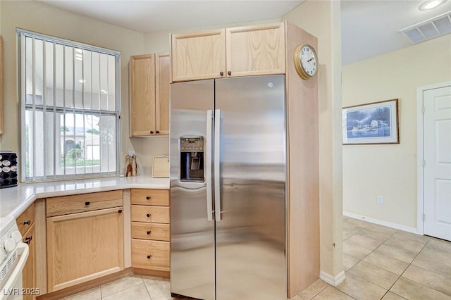 4508 Regalo Bello St, Las Vegas, NV 89135 - kitchen with stainless steel fridge with ice dispenser, light brown cabinetry, range, light tile patterned floors, and light countertops