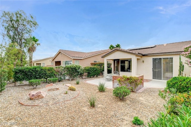 4508 Regalo Bello St, Las Vegas, NV 89135 - back of house featuring roof mounted solar panels, stucco siding, and a patio