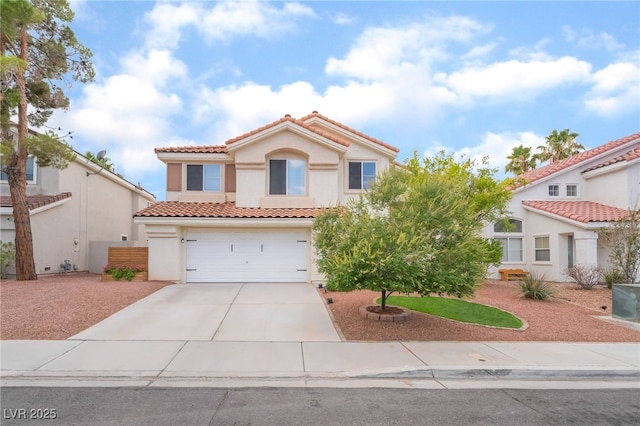 77 Huntfield Dr, Henderson, NV 89074 - mediterranean / spanish-style home with a tile roof, driveway, stucco siding, and a garage