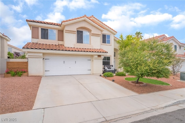 77 Huntfield Dr, Henderson, NV 89074 - mediterranean / spanish house featuring a tile roof, stucco siding, a garage, and concrete driveway