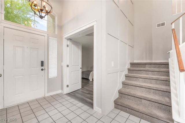 77 Huntfield Dr, Henderson, NV 89074 - entryway featuring stairs, light tile patterned floors, and a chandelier