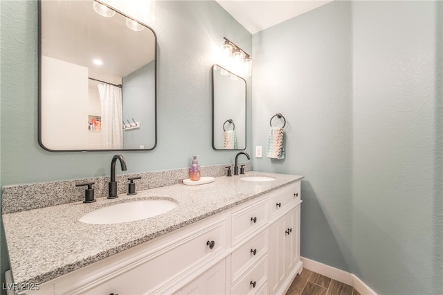 77 Huntfield Dr, Henderson, NV 89074 - bathroom with double vanity and wood finished floors