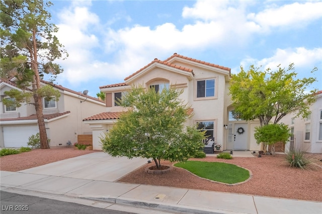 77 Huntfield Dr, Henderson, NV 89074 - mediterranean / spanish-style house featuring a tiled roof, concrete driveway, and stucco siding