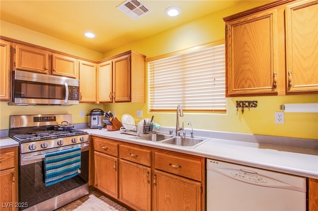 5587 Stomping Boots Ave, Las Vegas, NV 89118 - kitchen with stainless steel appliances, light countertops, and recessed lighting