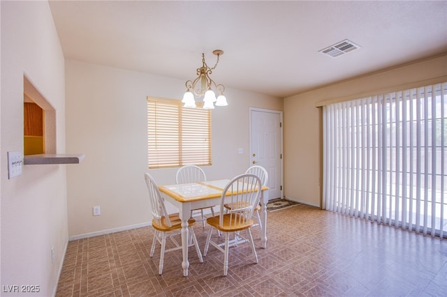 5587 Stomping Boots Ave, Las Vegas, NV 89118 - dining room with plenty of natural light, a chandelier, and tile patterned floors