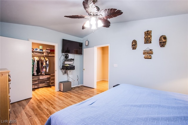 5587 Stomping Boots Ave, Las Vegas, NV 89118 - bedroom with light wood-style floors, vaulted ceiling, a walk in closet, a closet, and a ceiling fan