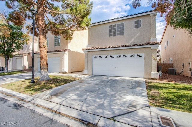 5587 Stomping Boots Ave, Las Vegas, NV 89118 - view of front of property with stucco siding, concrete driveway, a tiled roof, and a garage
