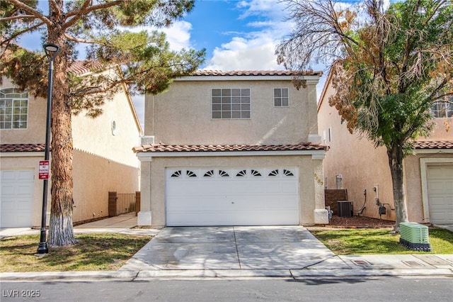 5587 Stomping Boots Ave, Las Vegas, NV 89118 - mediterranean / spanish-style house featuring a tile roof, stucco siding, concrete driveway, and an attached garage