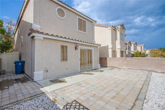 5587 Stomping Boots Ave, Las Vegas, NV 89118 - back of house featuring stucco siding, a tile roof, and a patio area