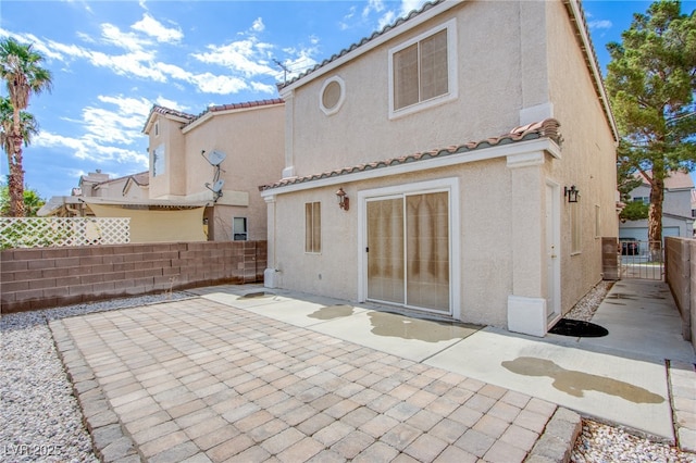 5587 Stomping Boots Ave, Las Vegas, NV 89118 - back of property with stucco siding, a fenced backyard, a patio area, and a tile roof