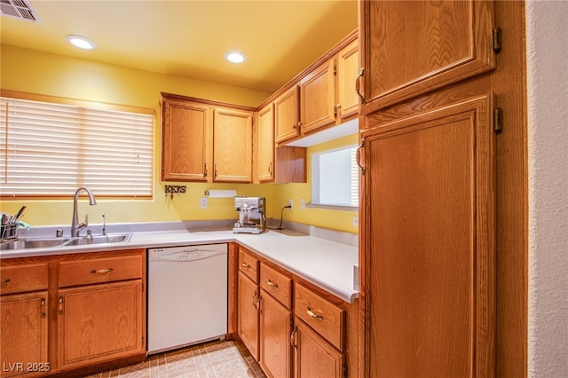 5587 Stomping Boots Ave, Las Vegas, NV 89118 - kitchen with white dishwasher, light countertops, recessed lighting, and brown cabinets