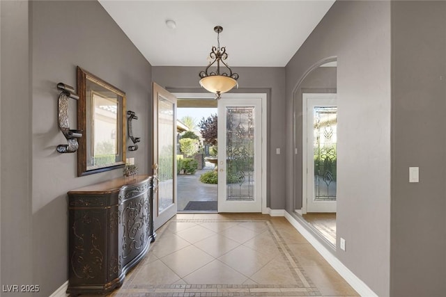 3668 Hillary Elan Ct, Las Vegas, NV 89139 - entrance foyer with arched walkways, light tile patterned flooring, french doors, and lofted ceiling
