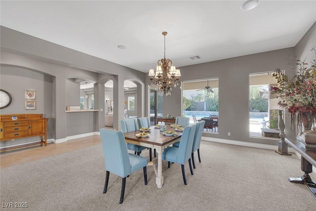 3668 Hillary Elan Ct, Las Vegas, NV 89139 - carpeted dining room with a chandelier and arched walkways
