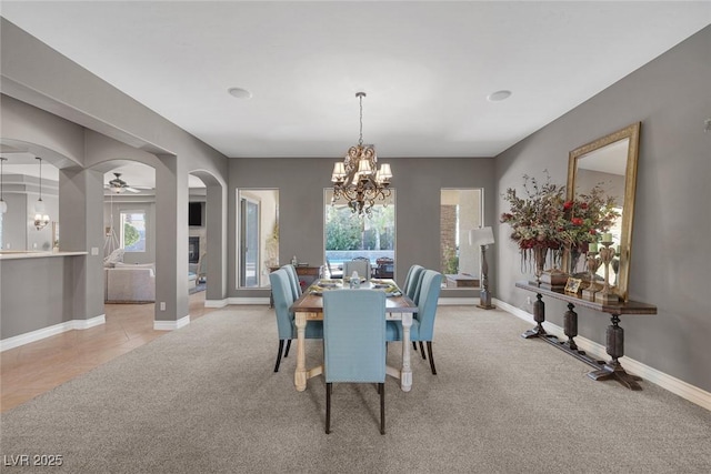 3668 Hillary Elan Ct, Las Vegas, NV 89139 - dining room with arched walkways, light colored carpet, a chandelier, and ceiling fan
