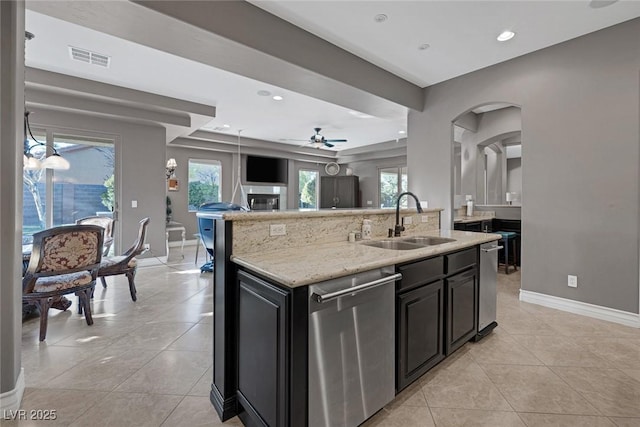 3668 Hillary Elan Ct, Las Vegas, NV 89139 - kitchen with dishwasher, open floor plan, light tile patterned floors, ceiling fan, and light stone countertops