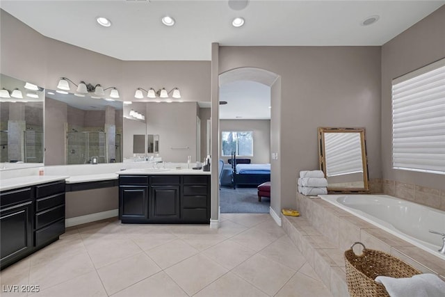 3668 Hillary Elan Ct, Las Vegas, NV 89139 - ensuite bathroom featuring vanity, a shower stall, a garden tub, tile patterned floors, and recessed lighting