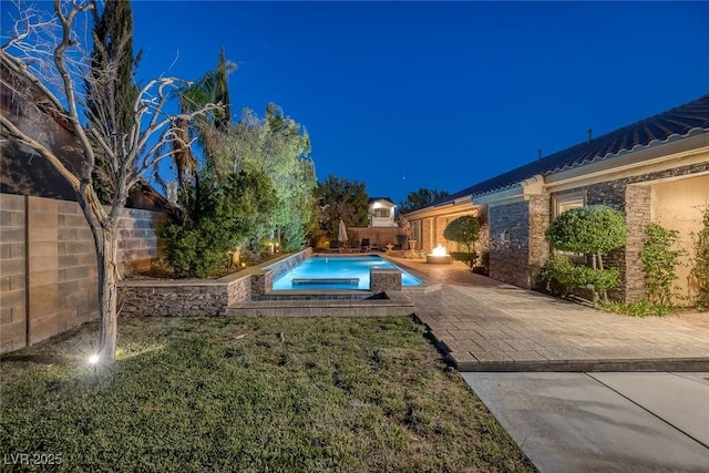 3668 Hillary Elan Ct, Las Vegas, NV 89139 - pool at night featuring an in-ground hot tub, a fenced backyard, and a patio