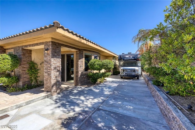 3668 Hillary Elan Ct, Las Vegas, NV 89139 - view of side of home with a tiled roof and concrete driveway