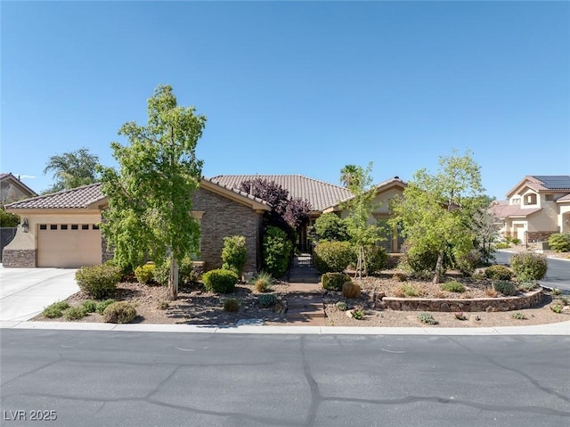 3668 Hillary Elan Ct, Las Vegas, NV 89139 - view of property hidden behind natural elements with a tiled roof, stucco siding, an attached garage, and concrete driveway