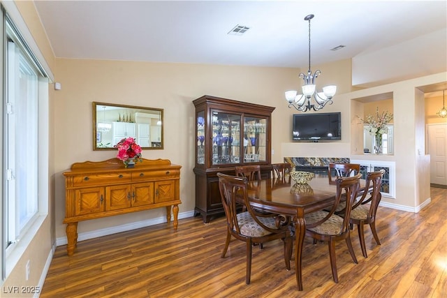 5620 Silver Belle St, Las Vegas, NV 89149 - dining space featuring a chandelier, wood finished floors, and plenty of natural light