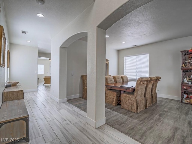 7375 Emerald Glow St, Las Vegas, NV 89123 - living room featuring arched walkways, light wood-style flooring, healthy amount of natural light, recessed lighting, and a textured ceiling