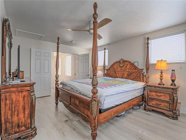 7375 Emerald Glow St, Las Vegas, NV 89123 - bedroom featuring light wood-style flooring, attic access, a textured ceiling, and a ceiling fan