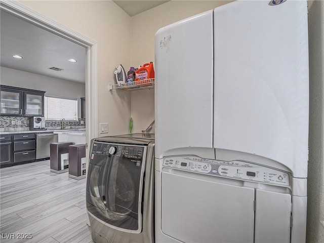 7375 Emerald Glow St, Las Vegas, NV 89123 - laundry room featuring separate washer and dryer, light wood-type flooring, and recessed lighting
